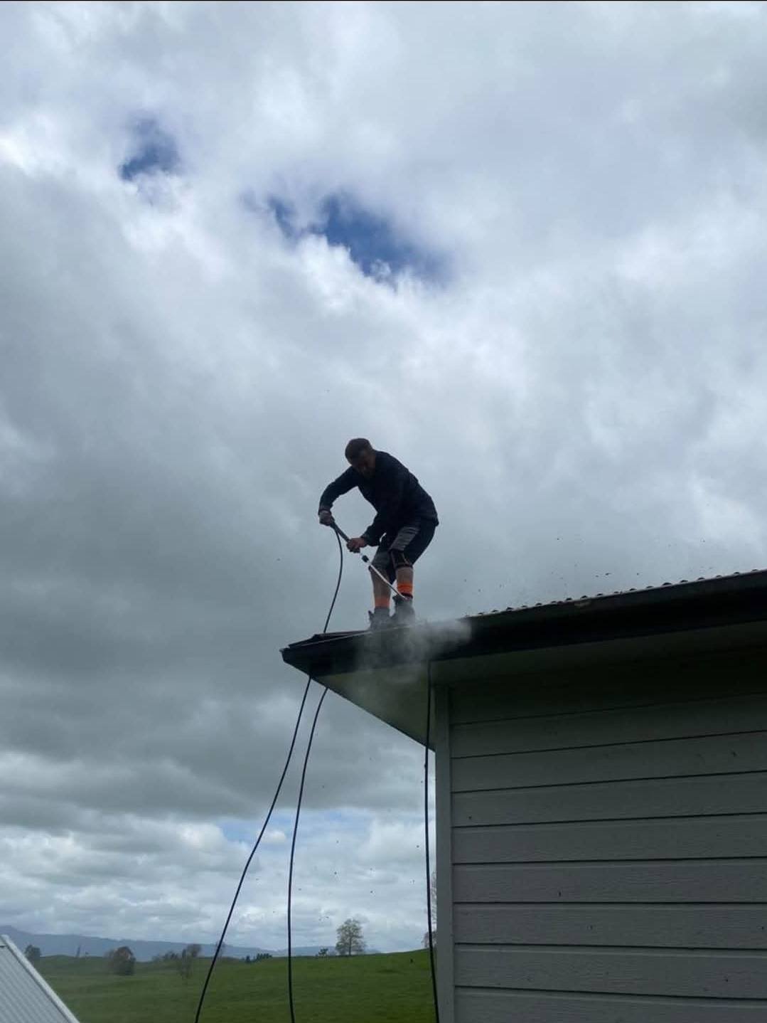 UP2IT technician cleaning gutters on NZ home